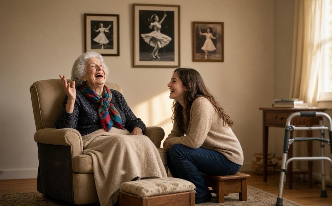 A woman in her late seventies laughing in her armchair as she tells her granddaughter a story